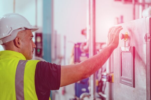 factory engineer staff pressing Emergency Stop Switch machine malfunctioning for safety