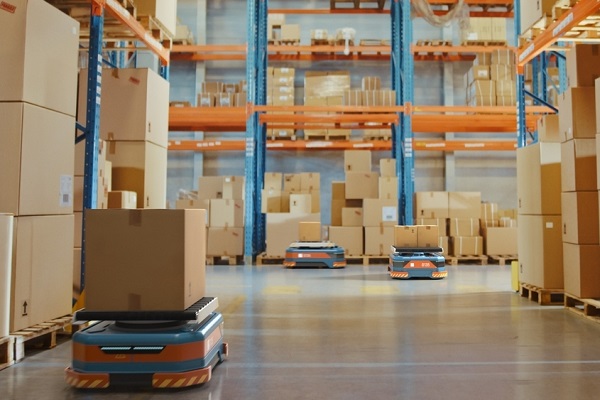 Automated Modern Retail Warehouse AGV Robots Transporting Cardboard Boxes