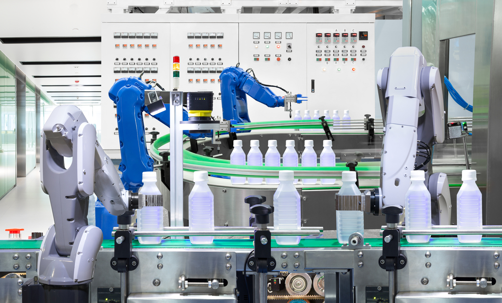 Robotic arm holding water bottles on production line in factory