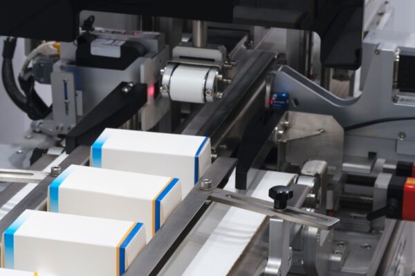 Automatic packaging conveyor line in pharmaceutical factory, pharmaceutical industrial concept background