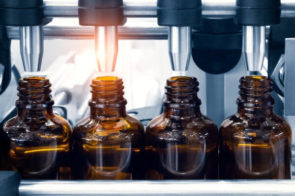 pharmaceutical industry, medicine pills are filling in the bottle on production line machine conveyor at the medical factory