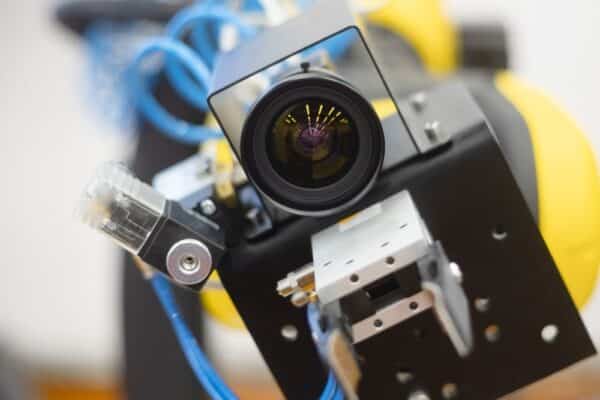 The manipulator arm uses a camera to observe and control objects and communication with a person