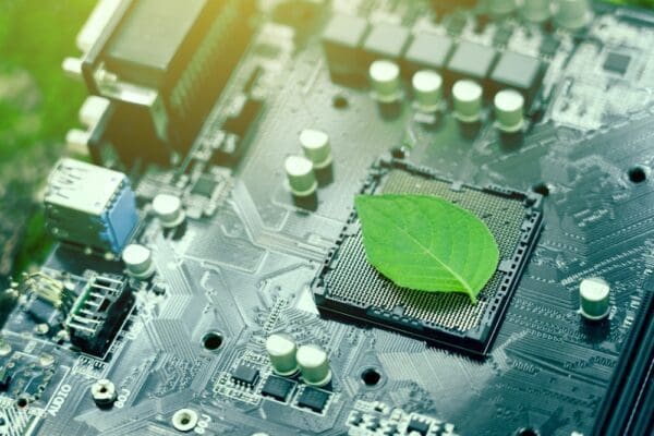 Green leaves inside a computer circuit board green technology and environmental technology
