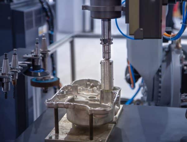 A CNC milling machine working on a metal housing