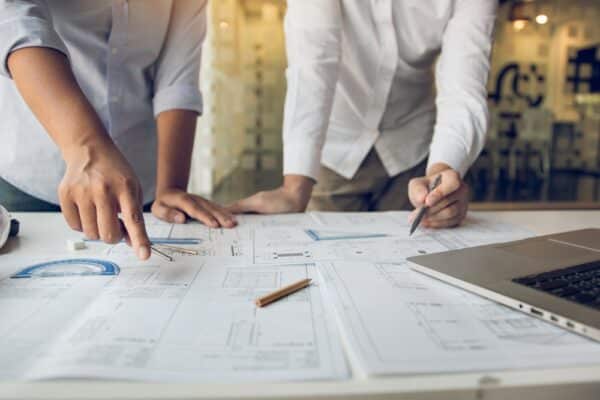 Engineers are helping to design work on blueprints